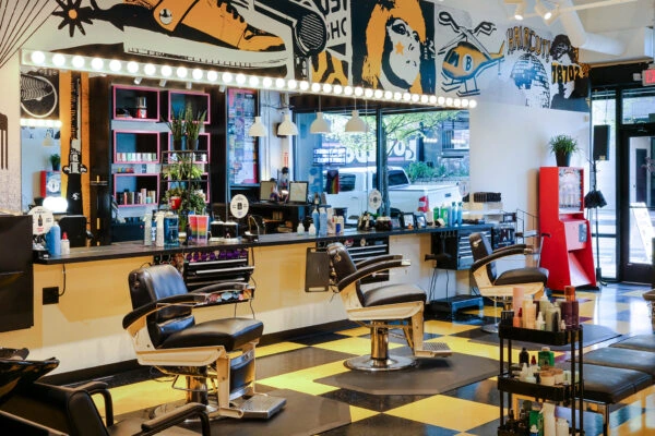 Interior of Birds Barbershop with barber chairs, mirrors, and colorful decor